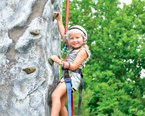 Young girl rock climbing