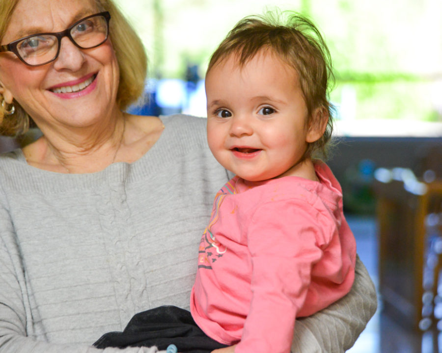 Woman holding a smiling toddler