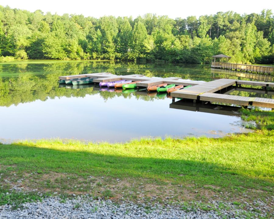 Small lake with dock and kayaks
