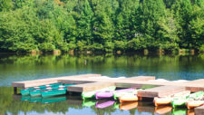 Lots of kayaks docked at a dock on the lake