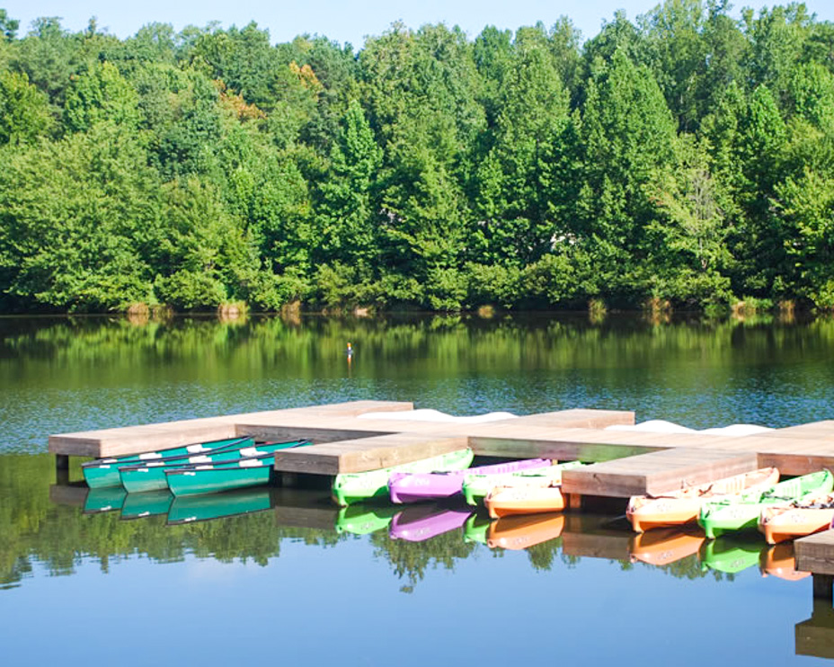 Lots of kayaks docked at a dock on the lake