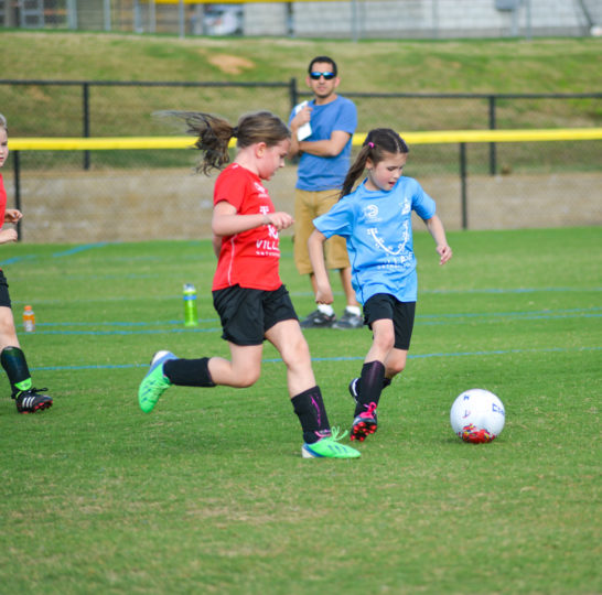 Girl team playing soccer
