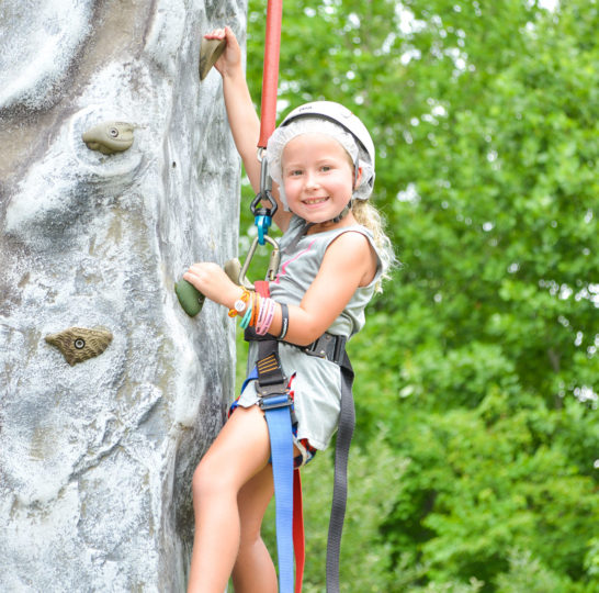 Young girl rock climbing