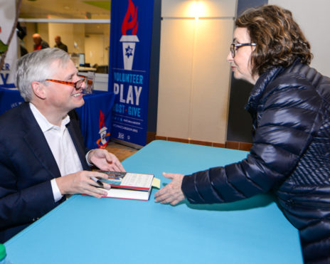 Woman getting her book signed by an author