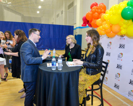 People mingling around a small table