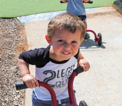 Preschool boy on a tricycle