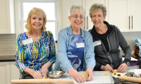 Three seniors cooking at Senior Day