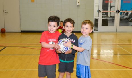 Boys holding a basketball in enrichment class