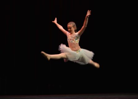 Young ballet dancer leaping at J Dance program