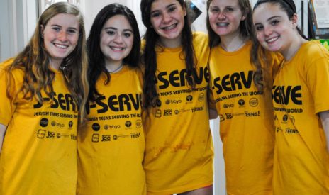 five girls smiling at a J-Serve International Day of Service event