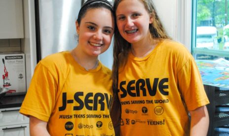 Two girls smiling at a J-Serve International Day of Service event