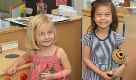 Two young children playing indoors at the Preschool Summer Camps (Infants-PreK) program