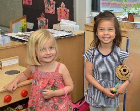 Two young children playing indoors at the Preschool Summer Camps (Infants-PreK) program