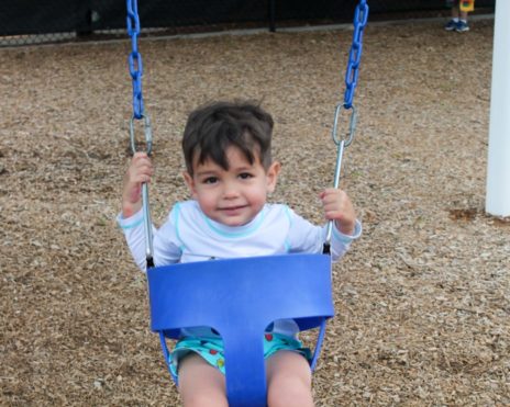 Toddler swinging at Preschool Summer Camp