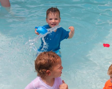 Toddler swimming in a pol at Preschool Summer Camp