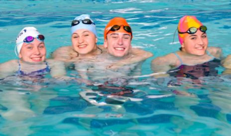 four teens in the pool at aquatics