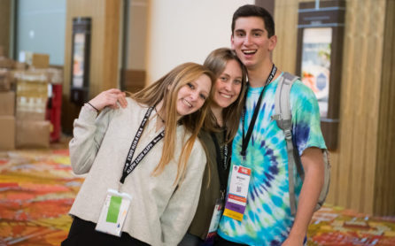 Three teens smiling at a teen convention