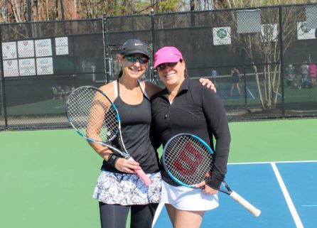 Two women holding tennis rackets at USTA tennis