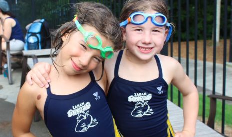 two girls smiling while at Sharks swim team